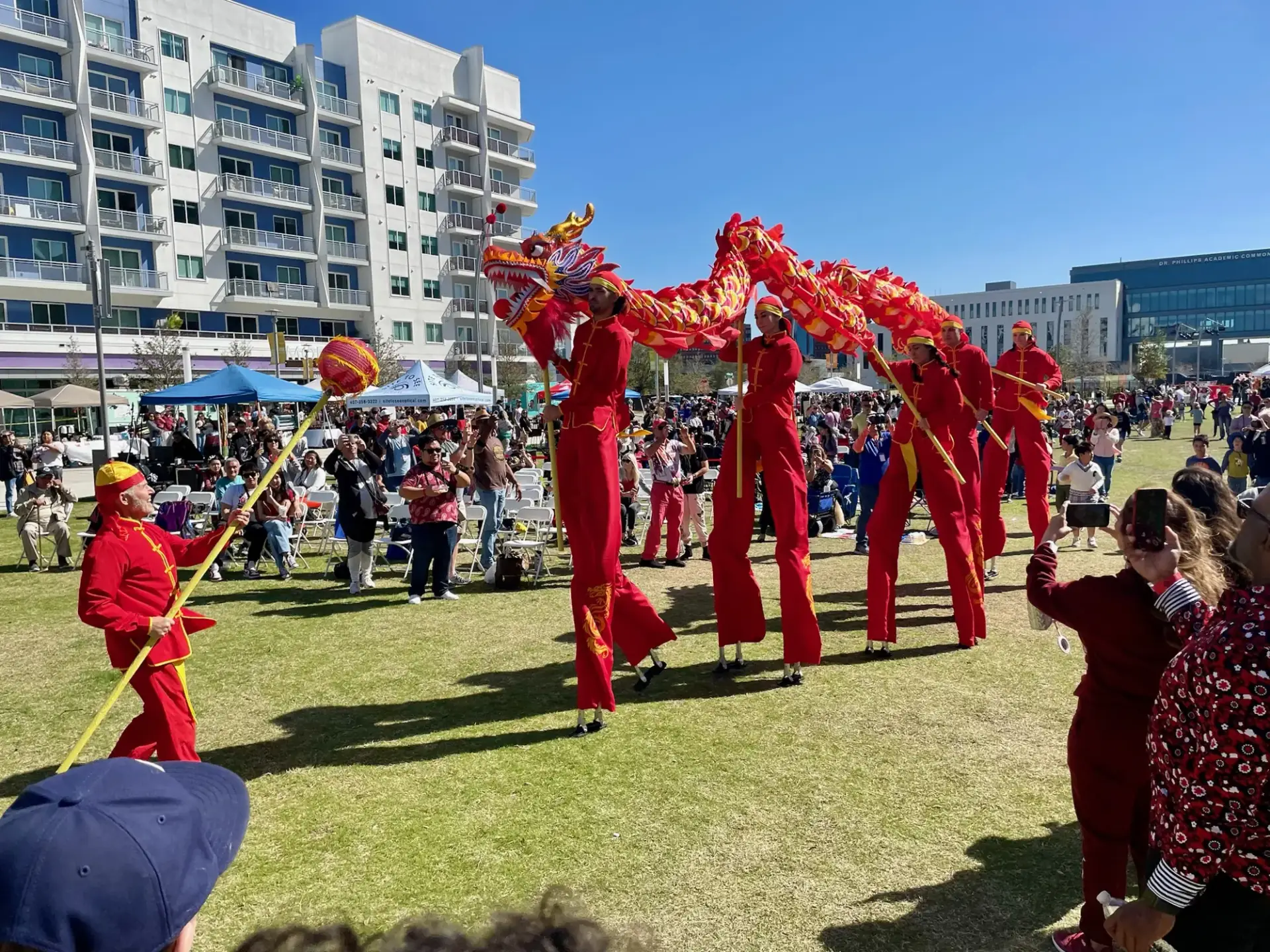 Dragon dance on stilts parading through the crowd
