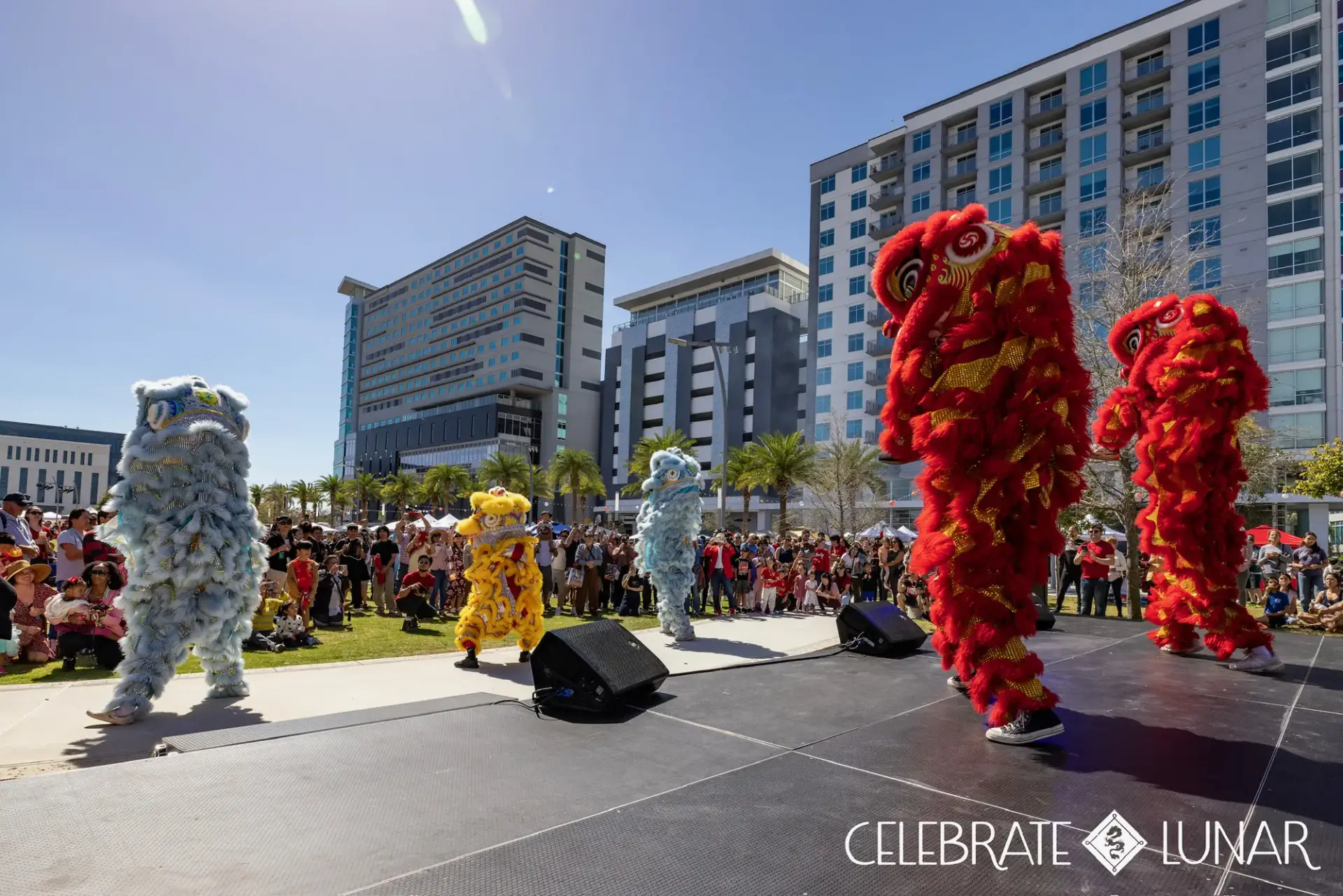 Red, gold and blue lions performing on the main stage
